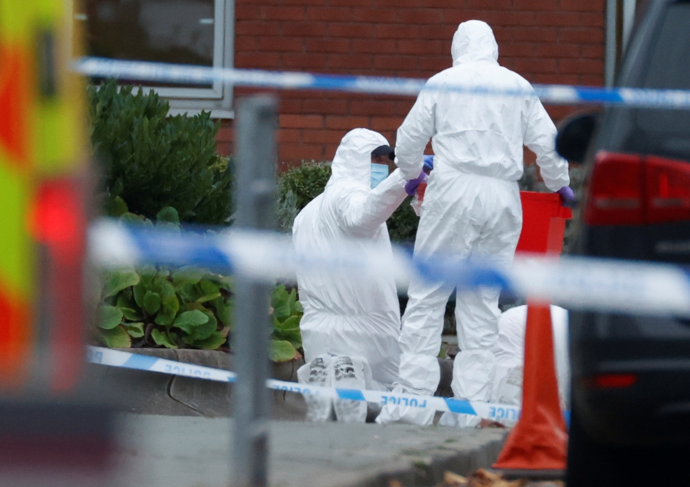 A police officer searching an area puts an item into a box at the scene of a car blast outside Liverpool Women's Hospital, in Liverpool, Britain, November 15, 2021. REUTERS/Phil Noble