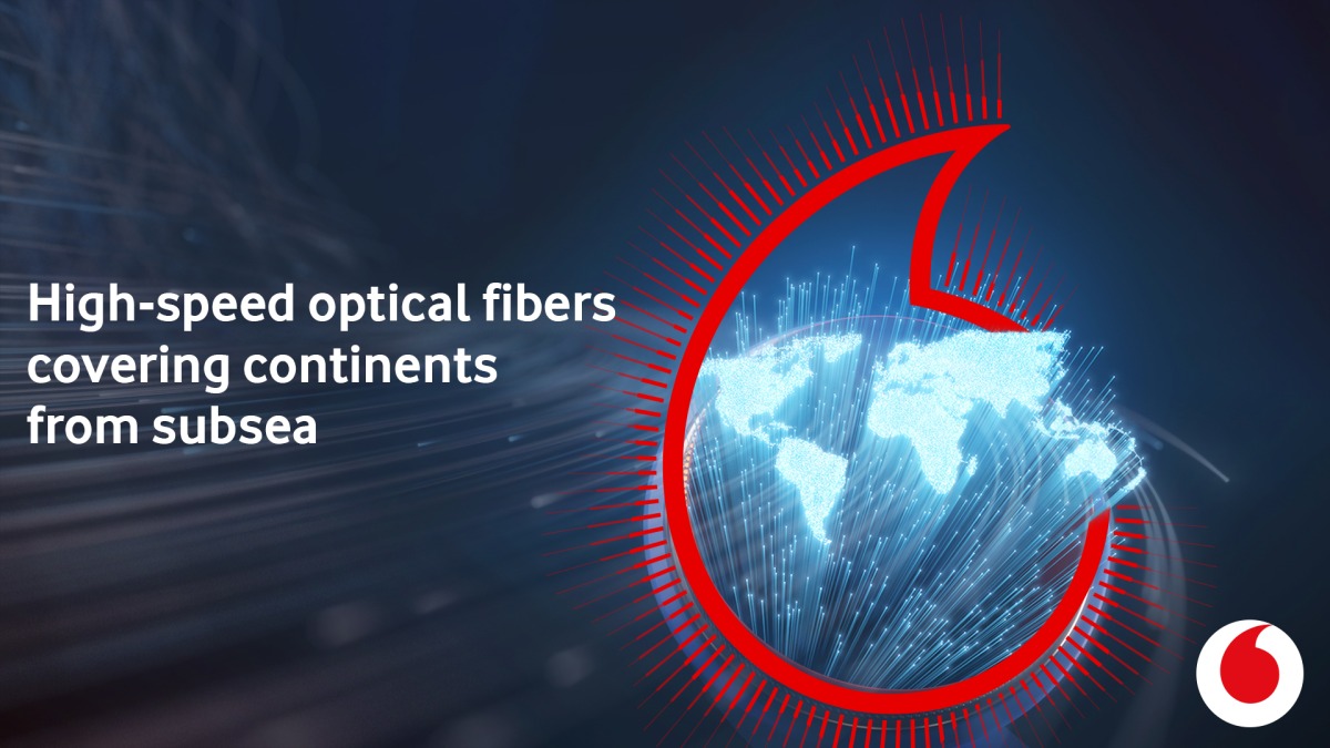 A 3D image concept of global communication shows optical fibers lit in the shape of the world map.