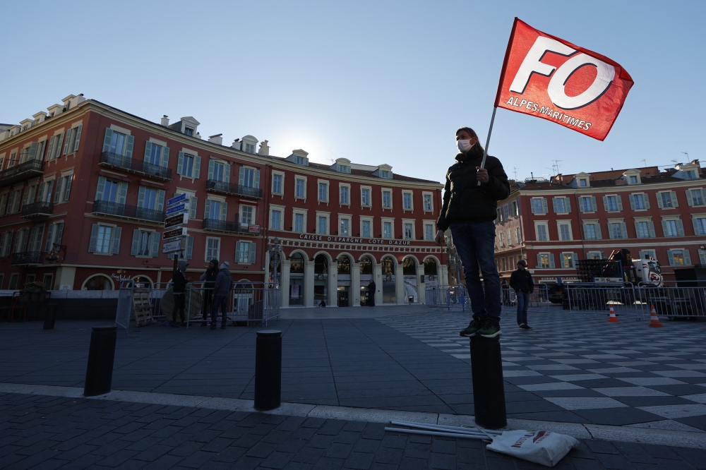 A man holds a flag of French Force Ouvriere (FO) labour union during a demonstration by French teachers in Nice. Reuters/Eric Gaillard