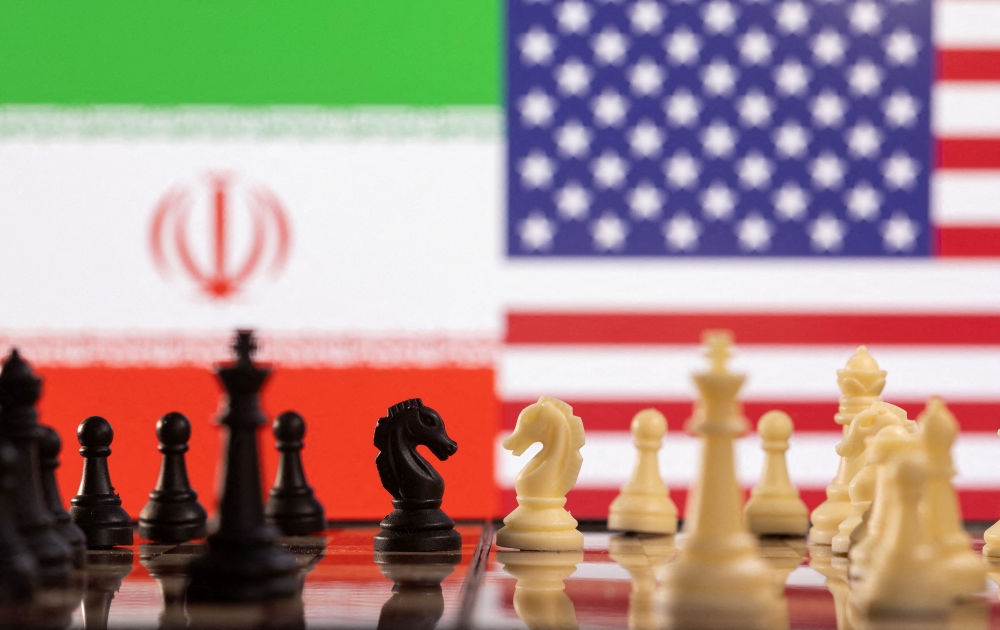 Chess pieces are seen in front of displayed Iran's and U.S. flags in this illustration taken January 25, 2022. REUTERS/Dado Ruvic/Illustration/File Photo