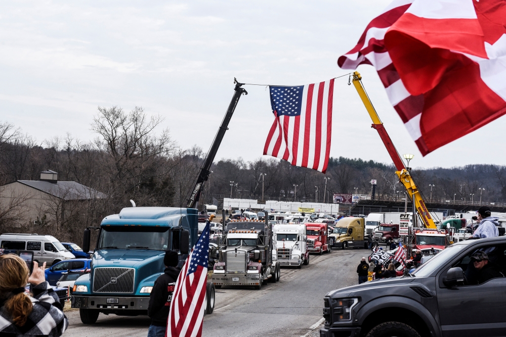 Hundreds of vehicles including 18-wheeler trucks, RVs and other cars depart the Hagerstown Speedway after some of them arrived as part of a convoy that traveled across the country headed to Washington D.C. to protest COVID-19 related mandates and other issues in Hagerstown, Maryland, U.S., March 6, 2022. REUTERS/Stephanie Keith
