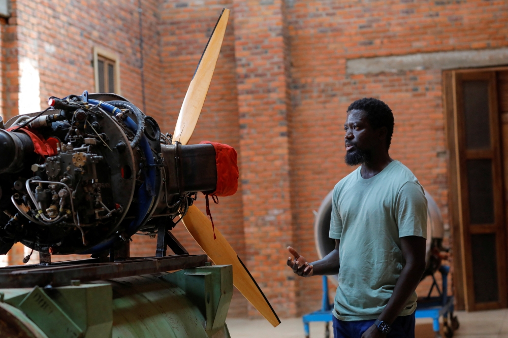 Ghanaian artist Ibrahim Mahama, 35, inspects an aircraft propeller engine at his studio facility in Tamale, Ghana, July 15, 2022. REUTERS/Francis Kokoroko