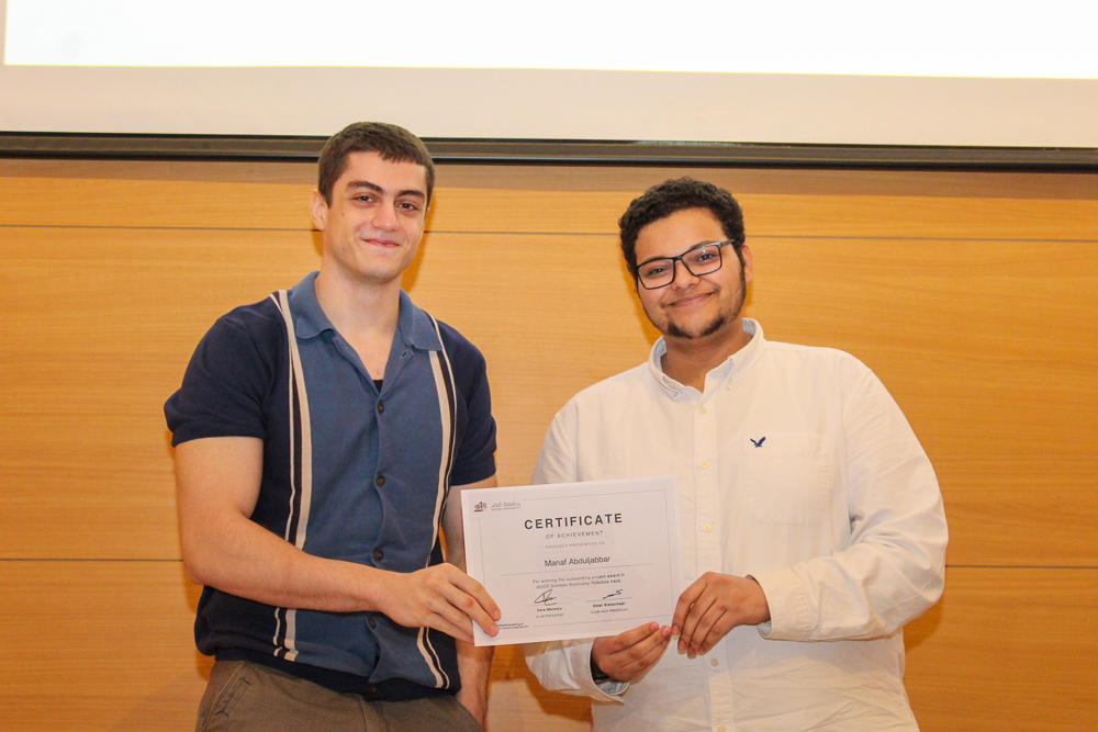 A student receiving the participation certificate. 