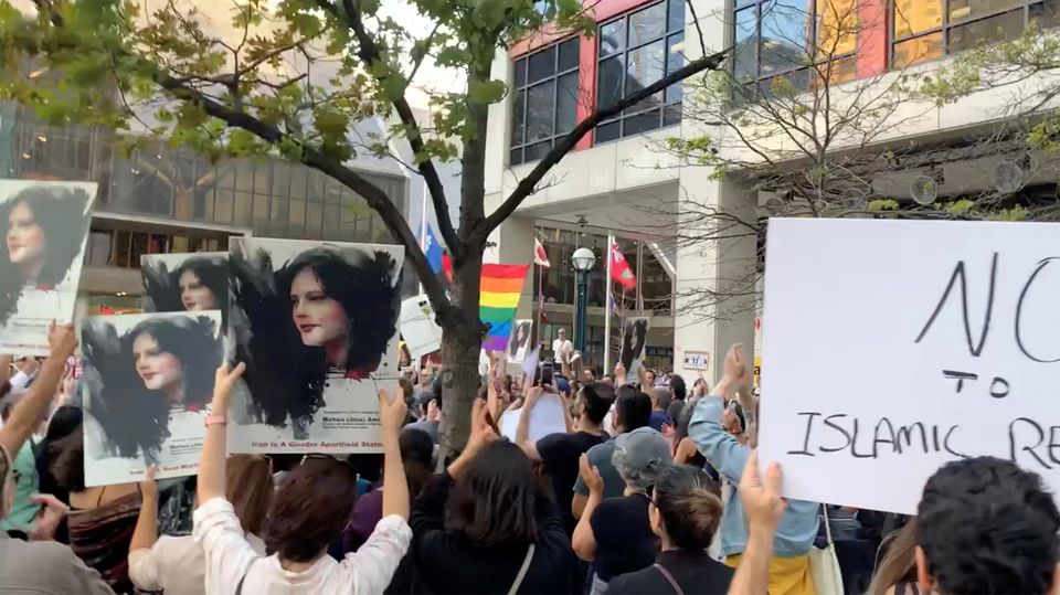 People attend a protest in solidarity with the women in Iran, following the death of Mahsa Amini, in Toronto, Canada, on September 19, 2022 in this screen grab obtained from social media video obtained by REUTERS.
