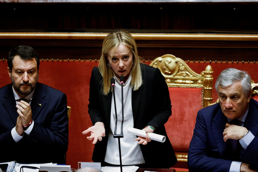 Italy's Prime Minister Giorgia Meloni speaks next to Foreign Affairs Minister Antonio Tajani and Infrastructure Minister Matteo Salvini during a session of the upper house of parliament ahead of a confidence vote for the new government, in Rome, Italy, on October 26, 2022. REUTERS/Guglielmo Mangiapane