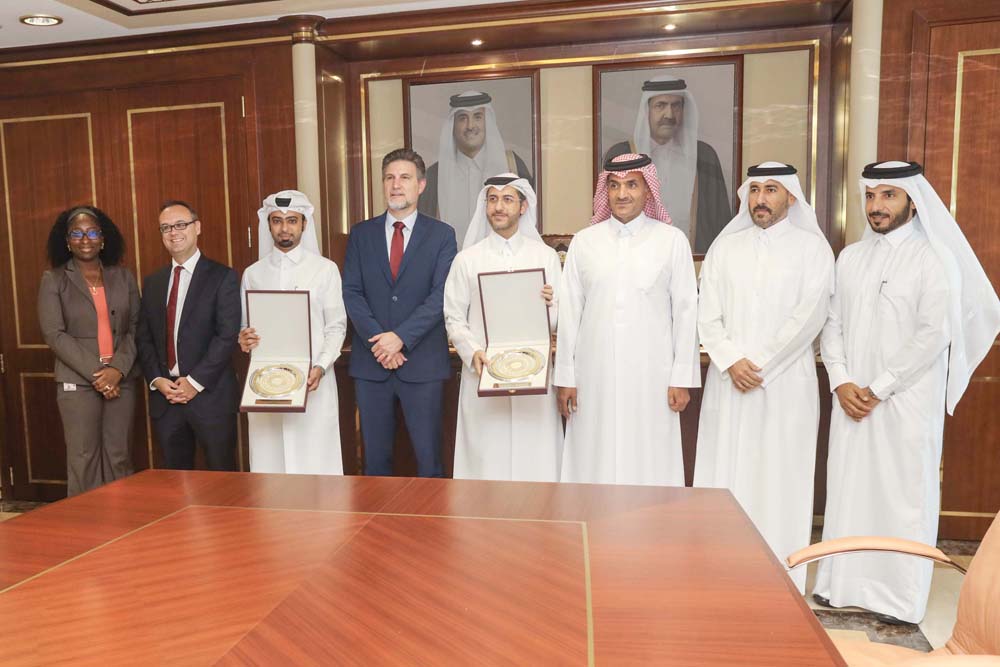 Officials pose for a group photo at Qatargas head office in Doha.
