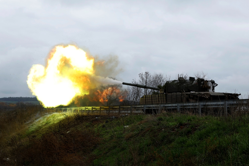 Ukrainian soldiers fire a round on the frontline from a T80 tank that was captured from Russians during a battle in Trostyanets in March, as Russia's invasion of Ukraine continues, in the eastern Donbas region of Bakhmut, Ukraine, on November 4, 2022. REUTERS/Clodagh Kilcoyne