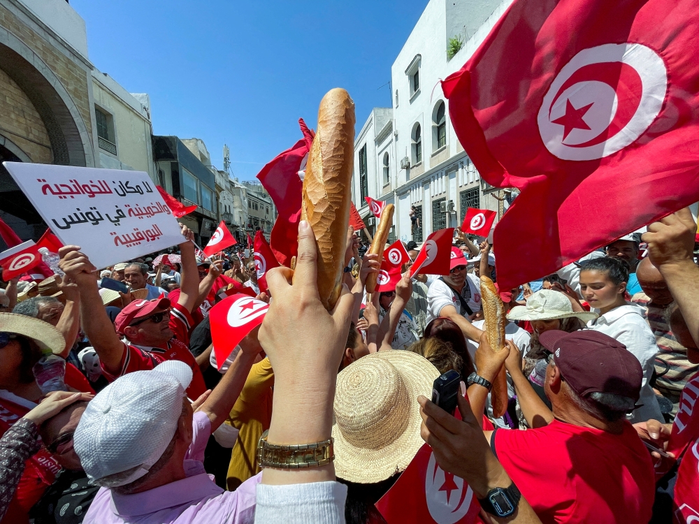 Demonstrators hold loaves of bread as they protest in opposition to a referendum on a new constitution called by President Kais Saied, in Tunis, Tunisia June 18, 2022. File Photo / Reuters