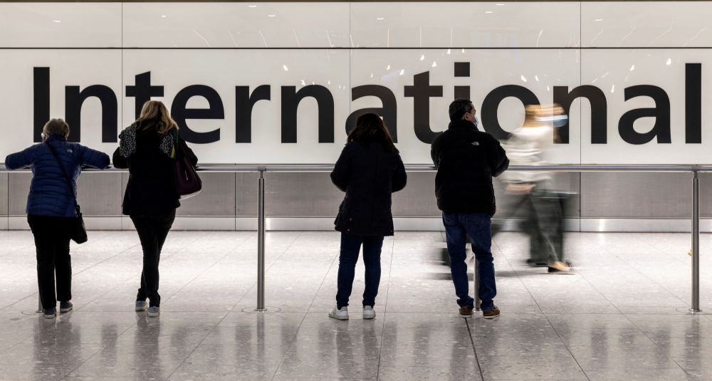 File Photo: People are seen waiting at the arrivals area of terminal 5 at Heathrow International airport following the lifting of restrictions on the entry of non-US citizens imposed to help curb the spread of the coronavirus disease (covid-19), in London, Britain November 8, 2021. (REUTERS/Carlos Barria)
