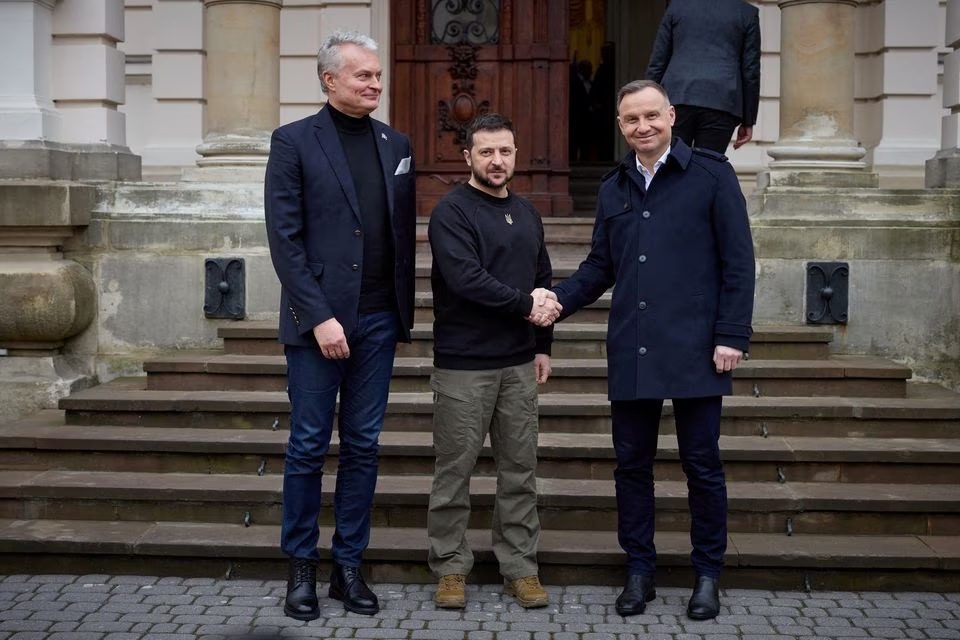 Ukrainian President Volodymyr Zelenskiy (C) welcomes Polish President Andrzej Duda (R) as Lithuanian President Gitanas Nauseda looks on, in Lviv, Ukraine, January 11, 2023. Ukrainian Presidential Press Service/Handout via REUTERS/File Photo
