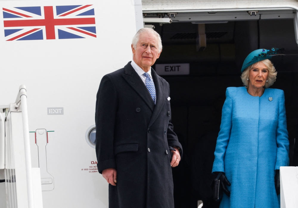 Britain's King Charles III (L) and Britain's Camilla, Queen Consort get off their plane after landing at Berlin Brandenburg Airport in Schoenefeld near Berlin, on March 29, 2023. Photo by Odd ANDERSEN / AFP