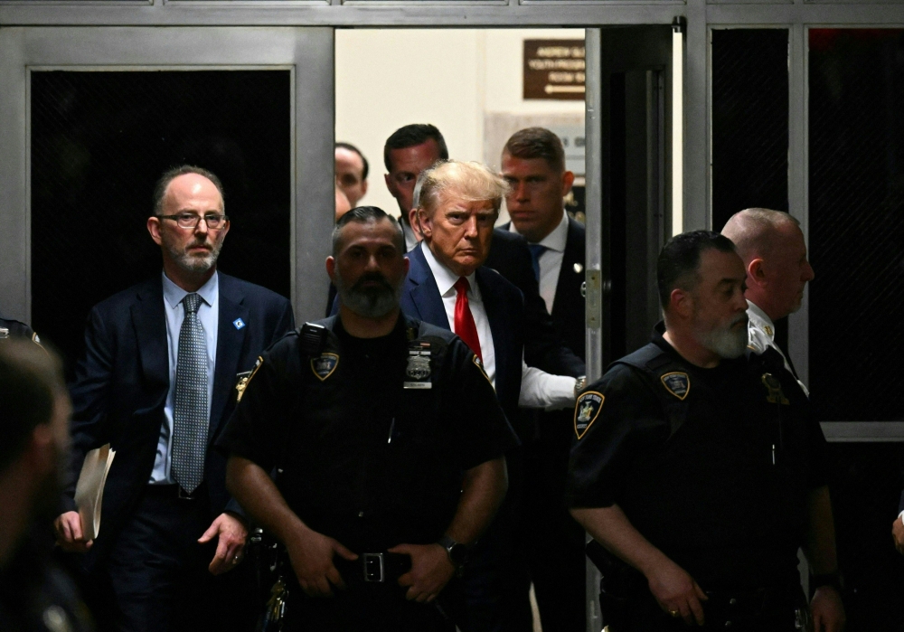 Former US President Donald Trump makes his way inside the Manhattan Criminal Courthouse in New York on April 4, 2023. (Photo by Ed Jones / AFP)