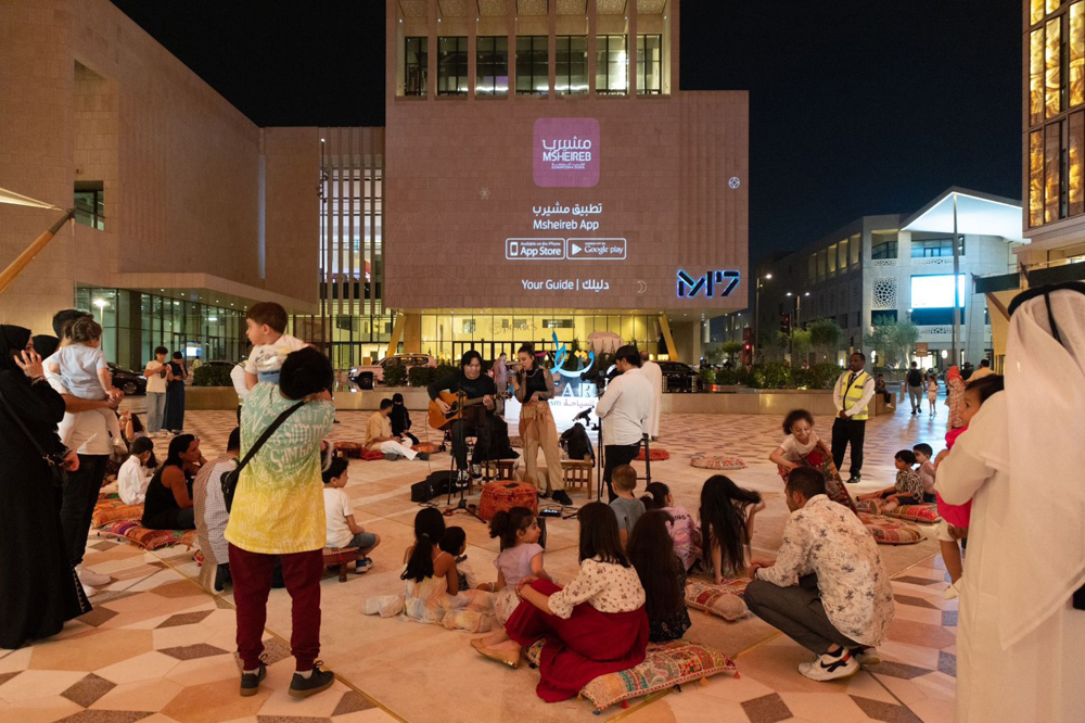 People enjoy a music performance at Msheireb Downtown Doha. 