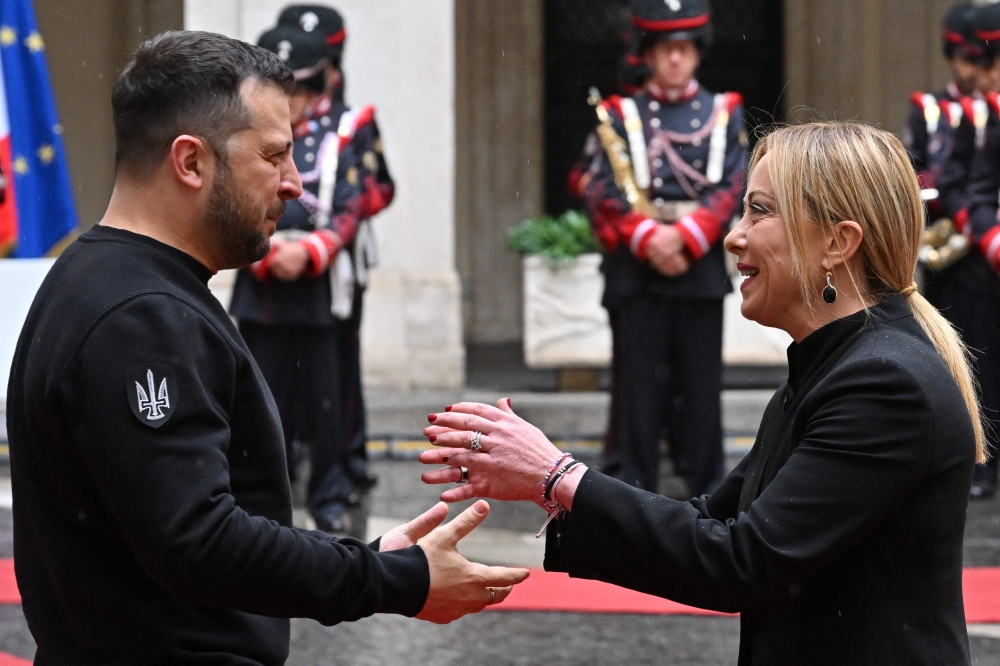 Italy's Prime Minister, Giorgia Meloni (R) greets Ukrainian President Volodymyr Zelensky upon his arrival for their meeting on May 13, 2023 at Palazzo Chigi in Rome.  Photo by Alberto PIZZOLI / AFP