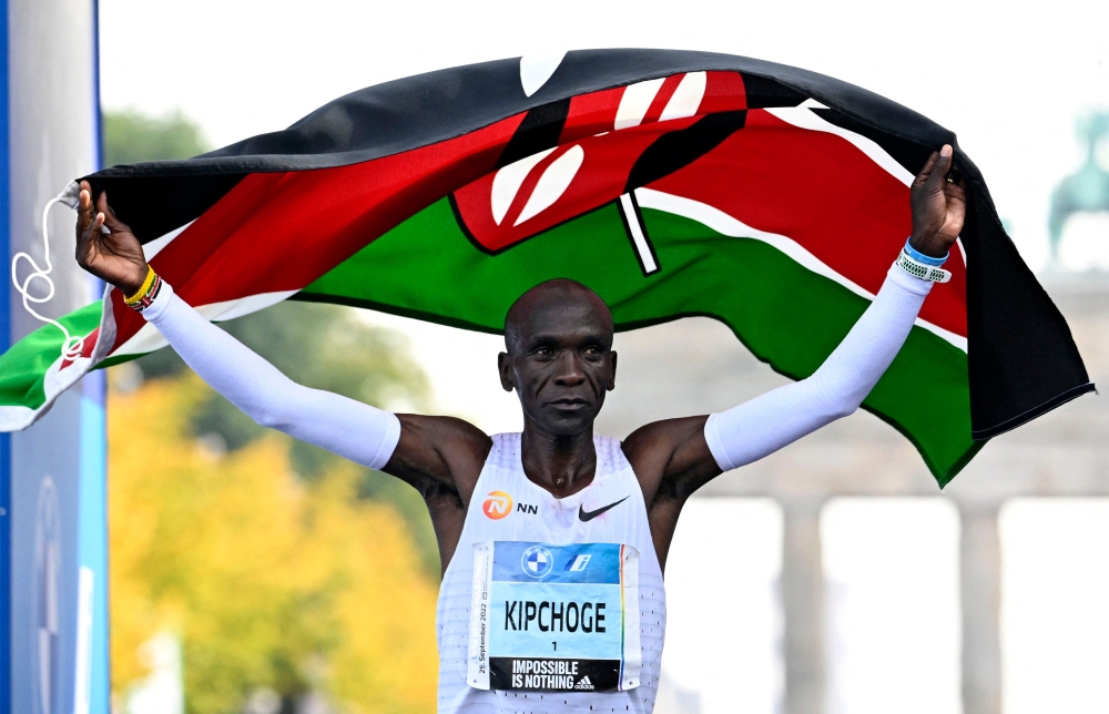 (Files) In this file photo taken on September 25, 2022 Kenya's Eliud Kipchoge crosses the finish line and wins the Berlin Marathon race in Berlin. (Photo by Tobias Schwarz / AFP)