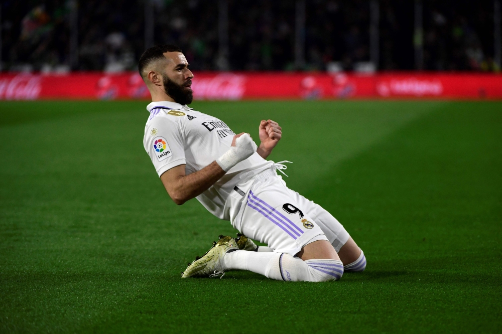 Real Madrid's French forward Karim Benzema celebrates scoring a goal that was later annulled during the Spanish League football match between Real Betis and Real Madrid CF at the Benito Villamarin stadium in Seville on March 5, 2023. (Photo by Cristina Quicler / AFP)
