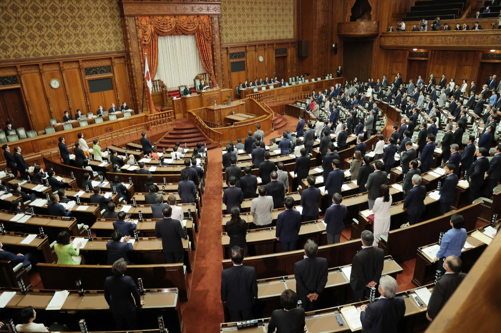 Members of the chamber vote to pass the revised Immigration Control and Refugee Recognition Act, which reviews the detention and deportation rules of foreigners, during a plenary session of the House of Councillors at the parliament building in Tokyo on June 9, 2023. (Photo by JIJI Press / AFP) 