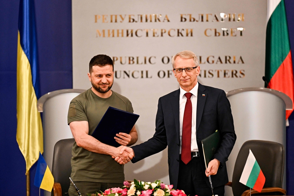 Ukrainian President Volodymyr Zelensky (left) with Bulgaria's Prime Minister Nikolai Denkov, after signing a memorandum prior to their joint press conference in Sofia, on July 6, 2023. (Photo by Nikolay Doychinov / AFP)