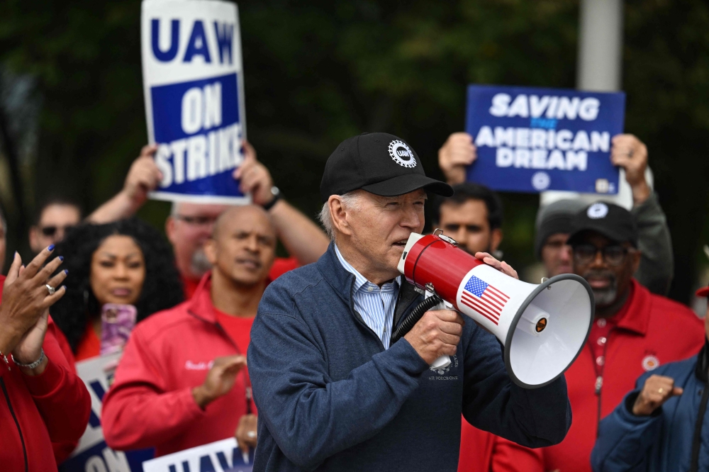 US President Joe Biden addresses striking members of the United Auto Workers (UAW) union at a picket line outside a General Motors Service Parts Operations plant in Belleville, Michigan, on September 26, 2023. (Photo by Jim Watson / AFP)