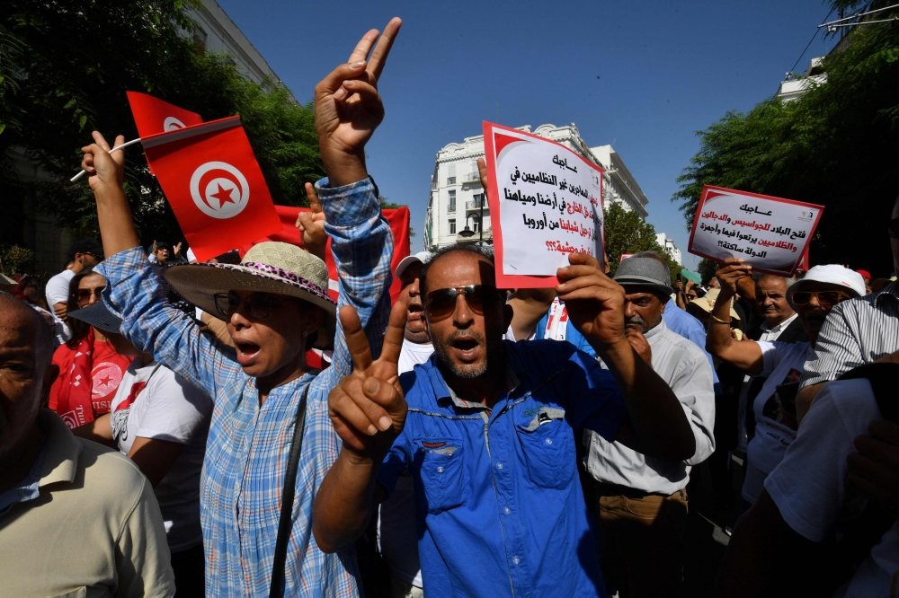 Supporters of the president of the Free Destourian Party (PDL) Abir Moussi shout slogans demanding her release during a demonstration organized in Tunis on October 15, 2023. (Photo by FETHI BELAID / AFP)
