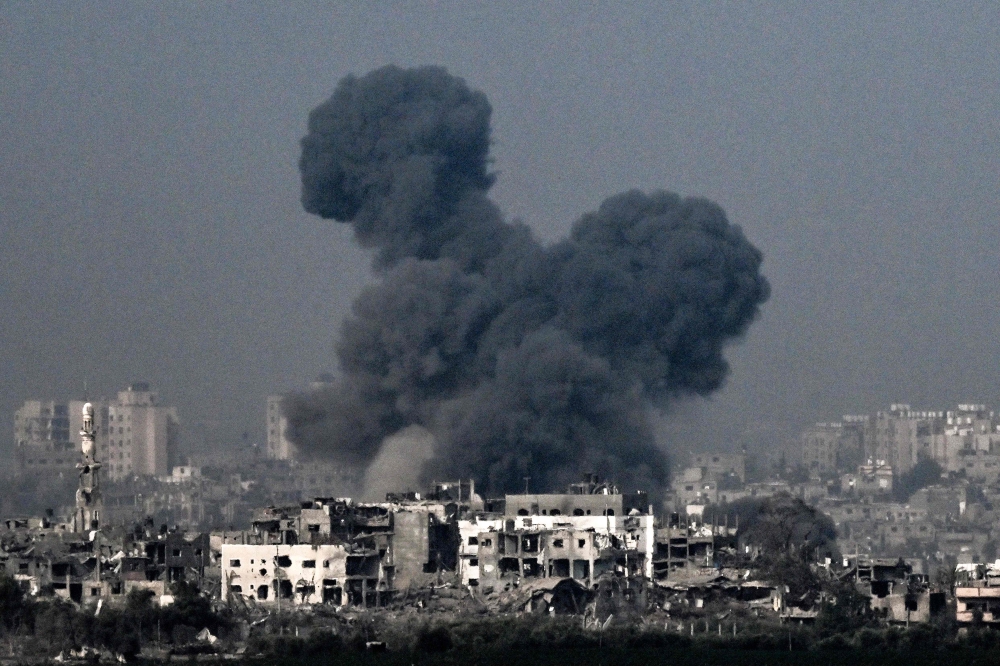 Smoke raising during an Israeli air strike in the northern Gaza Strip. (Photo by Aris MESSINIS / AFP)