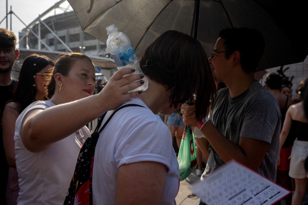 Fans of US singer Taylor Swift queue outside the Nilton Santos Olympic Stadium before Swift's concert,