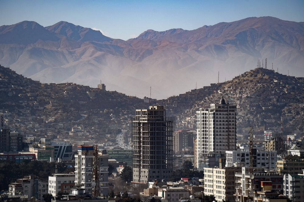 general view shows residential buildings against the backdrop of mountains in Kabul on January 16, 2024. (Photo by Omer ABRAR / AFP)
