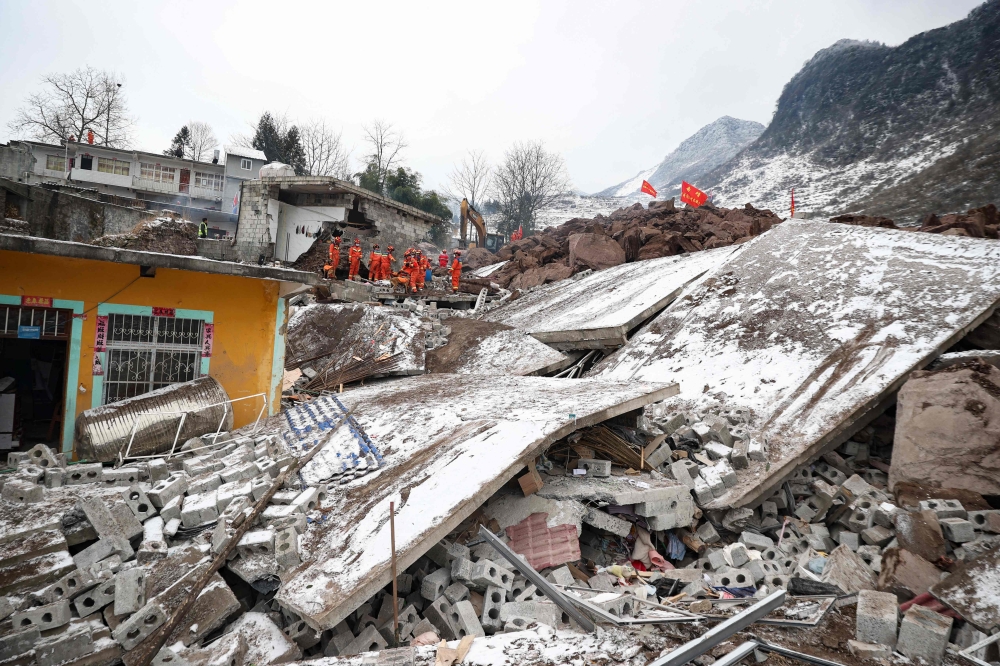 Rescue personnel search for missing victims following a landslide in Liangshui village at Zhaotong, in southwestern China's Yunnan province on January 22, 2024. Photo by AFP