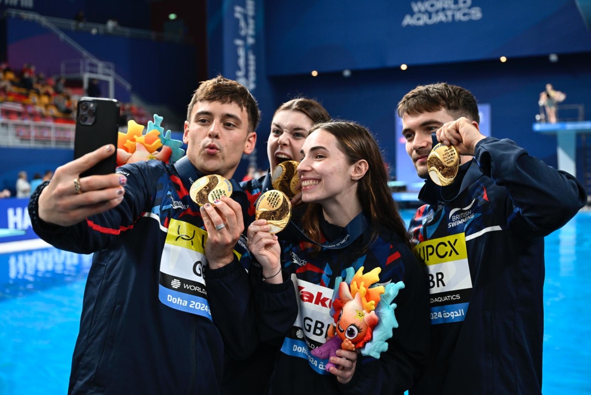 Great Britain's athletes pose for a selfie with their medals after winning the mixed team event.