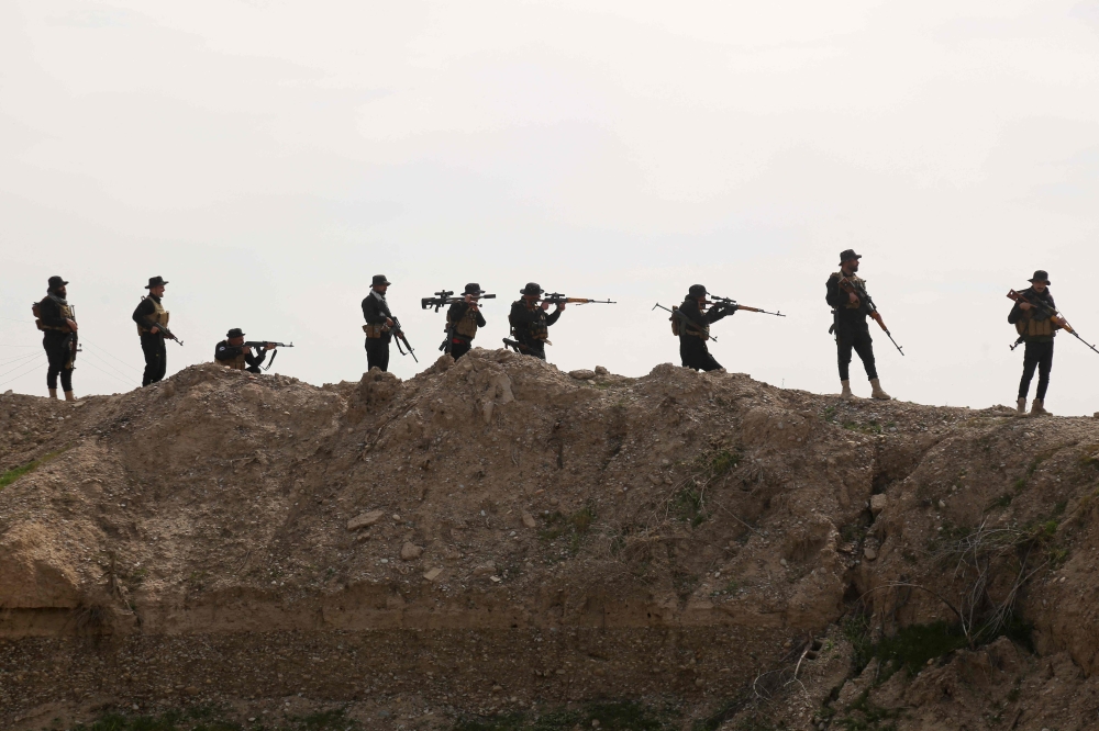 Iraqi forces take part in an anti-ISIS group operation, launched by Iraqi security forces, in al-Miqdadiyah in Iraq's Diyala province on March 10, 2024. (Photo by Younis AL-BAYATI / AFP)