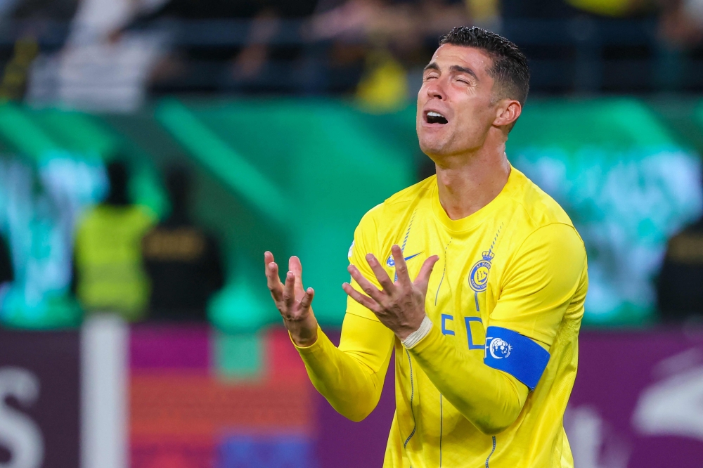 Nassr's Portuguese forward #07 Cristiano Ronaldo reacts during the AFC Champions League football match between Saudi Arabia's Al-Nassr and UAE's Al-Ain at Al-Awal Park Stadium in Riyadh on March 11, 2024. (Photo by Fayez Nureldine / AFP)