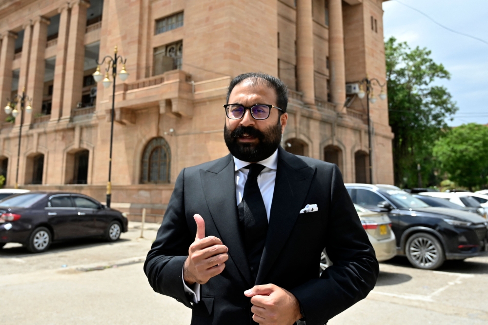 Moiz Jaaferi, a lawyer challenging the ban on social media platform X, talks to local media after a hearing at the Sindh High Court in Karachi on April 17, 2024. (Photo by Asif Hassan / AFP)
