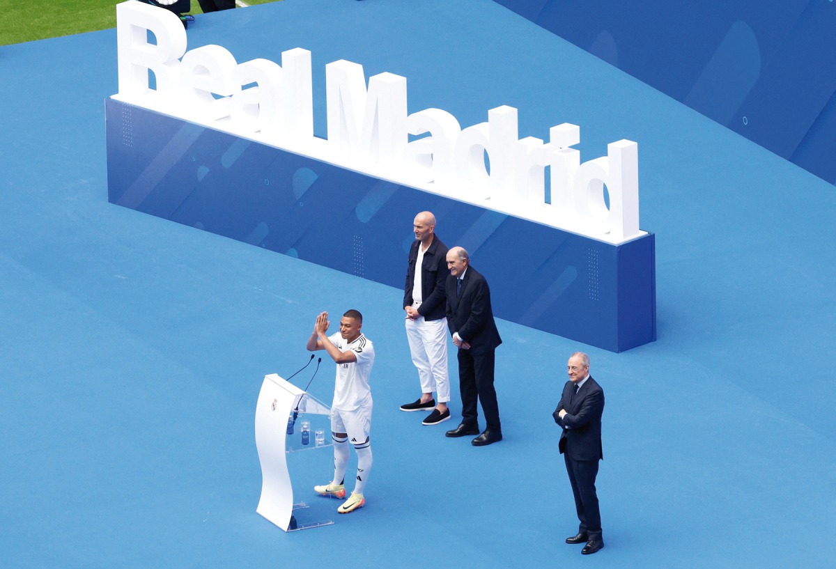 French forward Kylian Mbappe greets fans next to French former football player Zinedine Zidane (left), Real Madrid Honorary President Jose Martinez Pirri and Real Madrid’s President Florentino Perez (right) during his first appearance at the Santiago Bernabeu Stadium. AFP