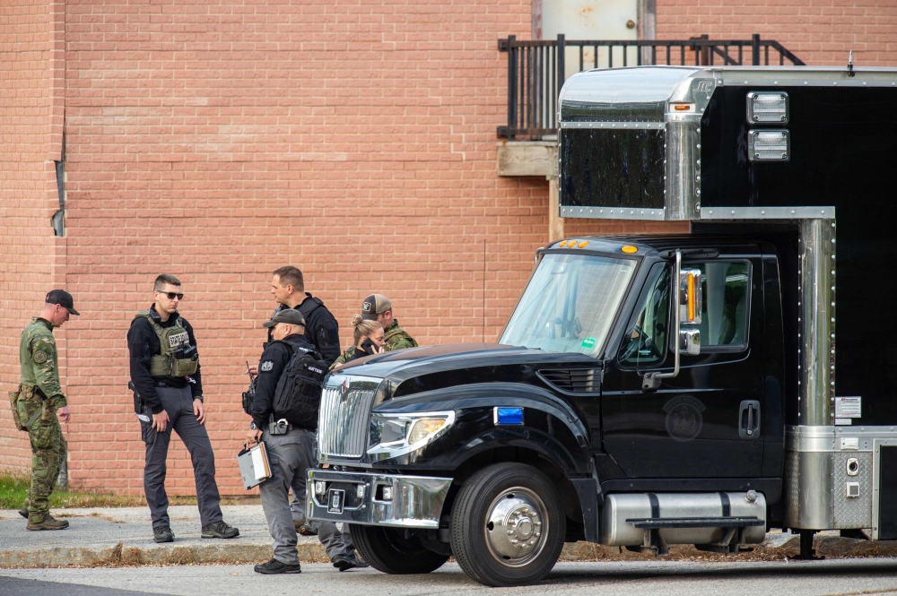 Law enforcement officers gather outside Lewiston High School, Maine on October 26, 2023. (Photo by Joseph Prezioso / AFP)

