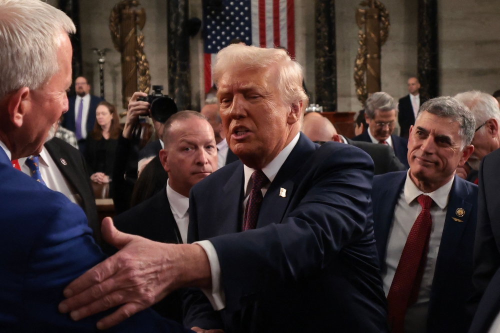 US President Donald Trump greets lawmakers as he leaves after addressing a joint session of Congress at the US Capitol in Washington, DC, on March 4, 2025. (Photo by Win McNamee / POOL / AFP)
