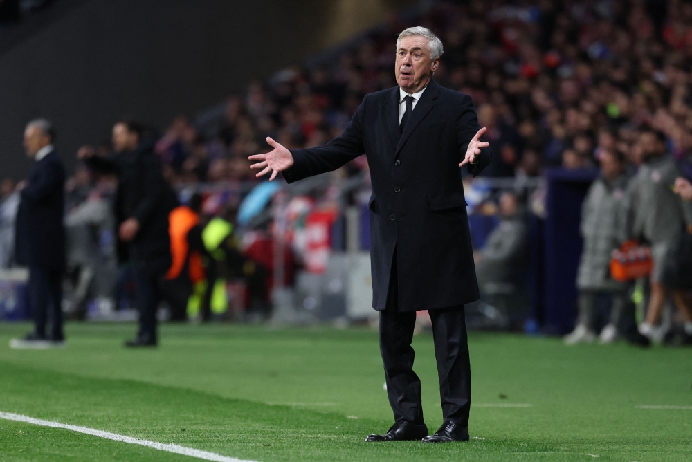 Real Madrid's Italian coach Carlo Ancelotti gestures during the UEFA Champions League Round of 16 second leg football match between Club Atletico de Madrid and Real Madrid CF at the Metropolitano stadium in Madrid on March 12, 2025. (Photo by Thomas Coex / AFP)