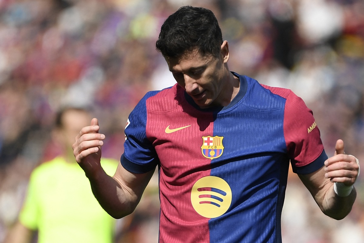 Barcelona's Polish forward #09 Robert Lewandowski reacts during the Spanish league football match between FC Barcelona and RC Celta de Vigo at the Estadi Olimpic Lluis Companys in Barcelona on April 19, 2025. (Photo by Josep LAGO / AFP)