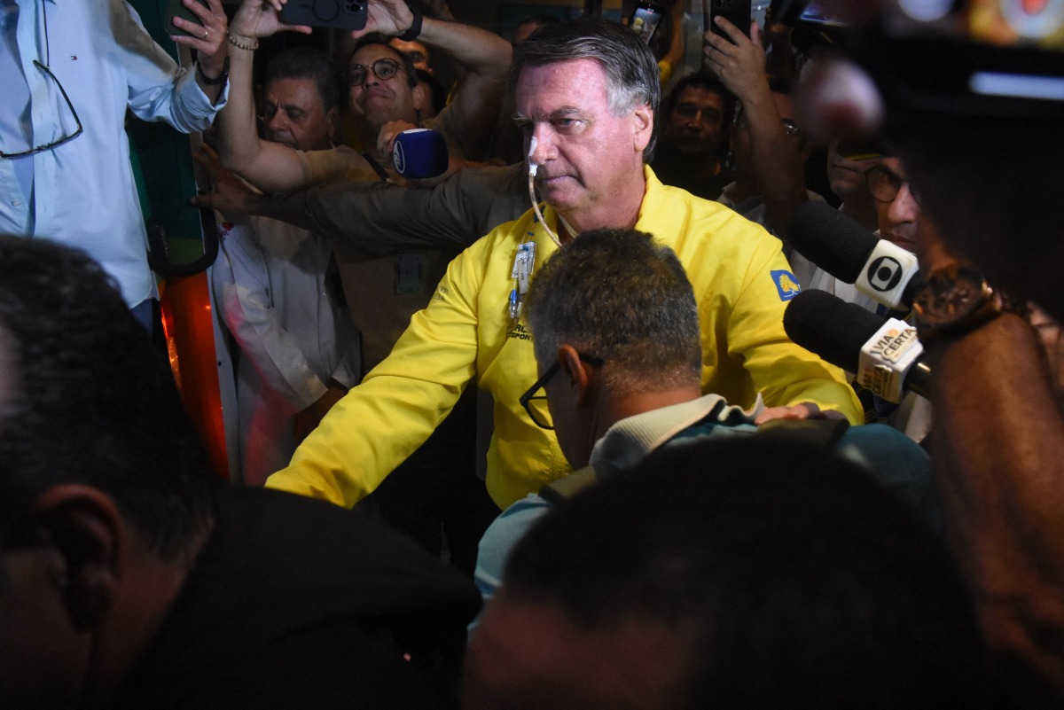 (FILES) Former Brazilian President Jair Bolsonaro is pictured before boarding an ambulance as he leaves Rio Grande Hospital in Natal, Rio Grande do Norte state, Brazil, on April 12, 2025. (Photo by Jose ALDENIR / AFP)
