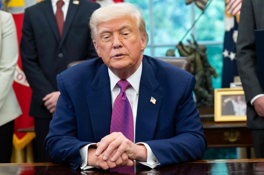 US President Donald Trump speaks while signing an executive order on legislation relating to household consumer energy policies, in the Oval Office of the White House in Washington, DC, on May 9, 2025. (Photo by Saul Loeb / AFP)