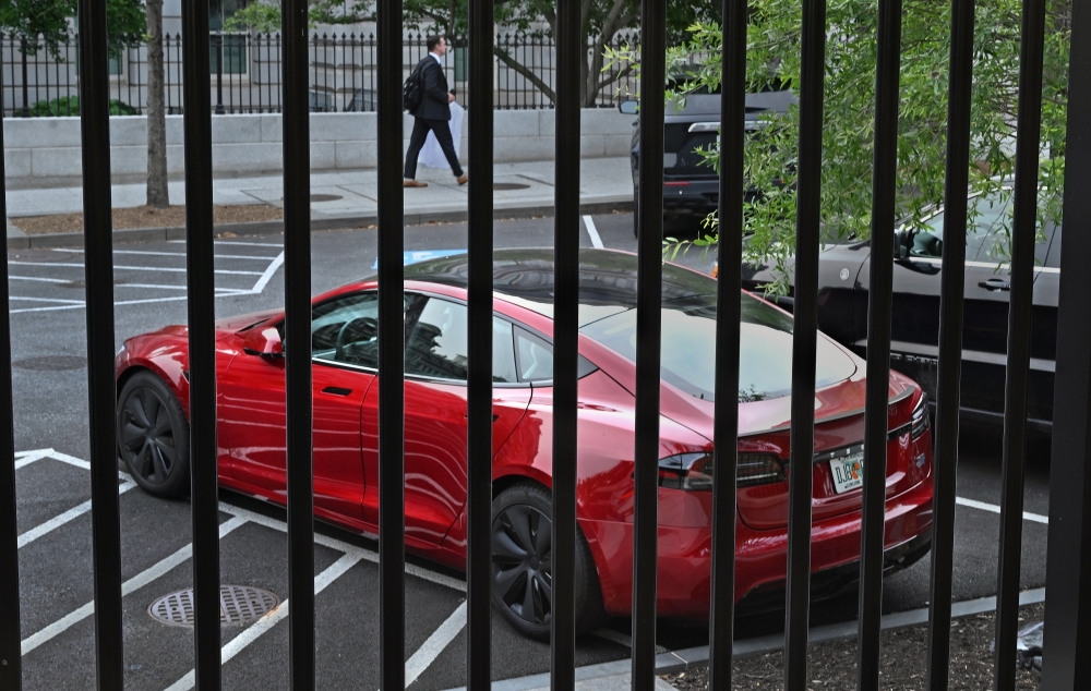 A Tesla automobile owned by President Donald Trump (he does not drive it, but some staffers do) is parked in a lot next to the White House fence Thursday. Michael S. Williamson/The Washington Post