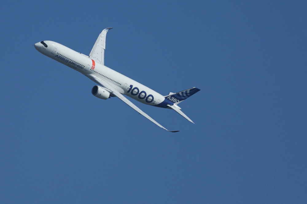 This photograph shows an Airbus A350-1000 passenger aircraft performing an exhibition flight demonstration during the 55th edition of the International Paris Air Show on June 16, 2025. (Photo by Alain Jocard / AFP)