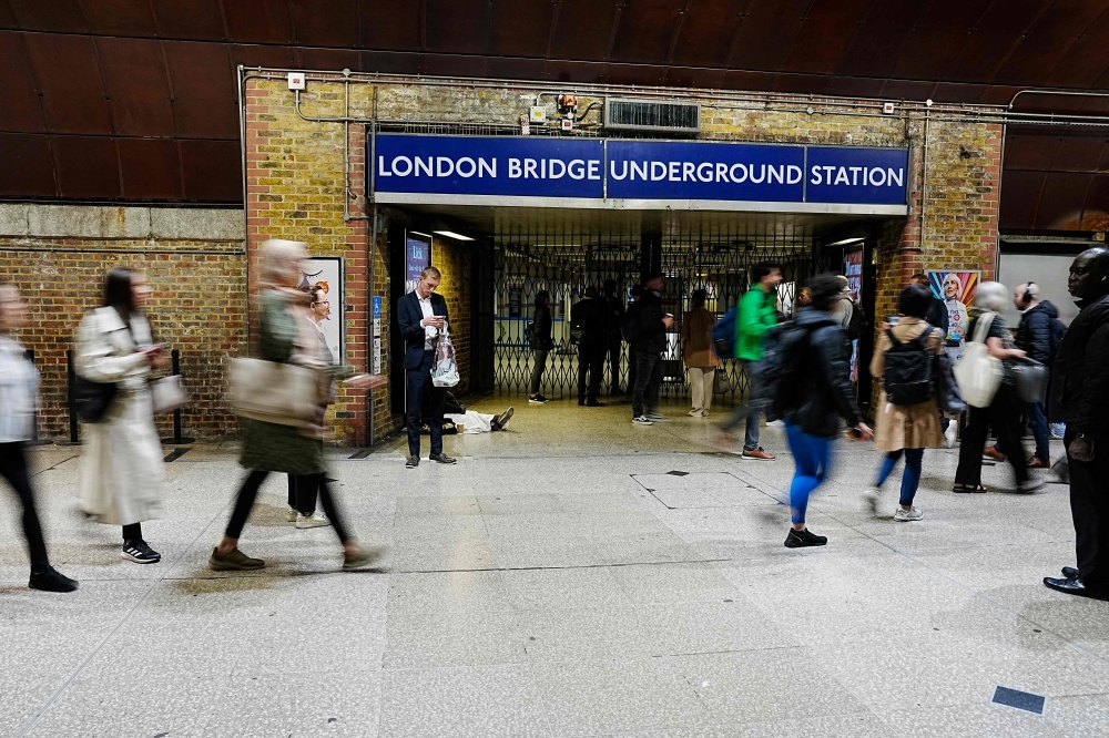 Pedestrians pass one of the closed entrances to London Bridge Underground Station in London on September 8, 2025. (Photo by Carlos Jasso / AFP)