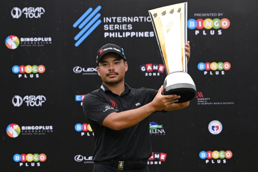 Philippines' Miguel Tabuena holds up the trophy after winning the International Series Philippines golf tournament at Sta. Elena Golf Club in Santa Rosa, Laguna province on October 26, 2025. (Photos by Ted Aljibe / AFP)