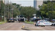 Investigators looks over the scene where nine individuals were shot at a strip mall along Weslayan St. on September 26, 2016 in Houston, Texas. Bob Levey/AFP

