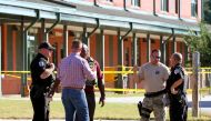 Anderson County sheriff's deputies and investigators gather outside of Townville Elementary School after a shooting in Townville, South Carolina, U.S., September 28, 2016. REUTERS/Nathan Gray 
