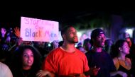 Protesters gather along Broadway Avenue to protest the fatal shooting of an unarmed black man on Tuesday by officers in El Cajon, California, U.S. September 28, 2016. REUTERS/Sandy Huffaker