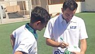 Supreme Committee for Delivery and Legacy’s (SC) Generation Amazing ambassador Xavi (right) signs an autograph during the practice session. 