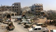 Libyan forces allied with the U.N.-backed government gather outside destroyed buildings they captured from Islamic State militants in neighbourhood Number Three in Sirte, Libya October 3, 2016. REUTERS/Hani Amara