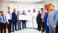 Officials from Lulu Hypermarket handing over a cheque of QR275,000 to RAF officials in a ceremony at Lulu D-Ring Road branch.