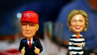 Bobble head figurines of Republican presidential nominee Donald Trump and Democratic presidential nominee Hillary Clinton greet party supporters registering to watch a presidential debate watch party hosted by the Colorado Republican Party at Choppers Spo